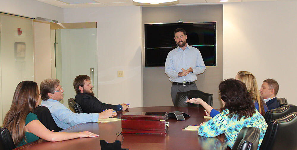 Sean Estes leading a staff meeting