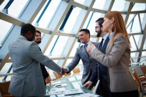 Partnership Dispute Lawyer Tampa, FL - Business partners handshaking upon striking deal in office